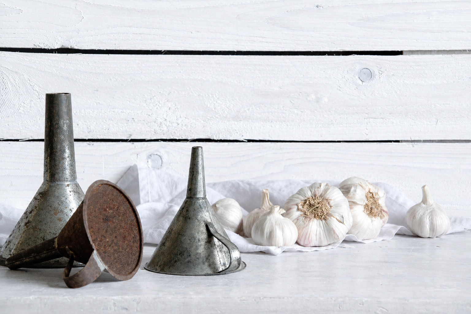 Vintage metal funnel with rustic patina and timeworn surface used as candle holder
