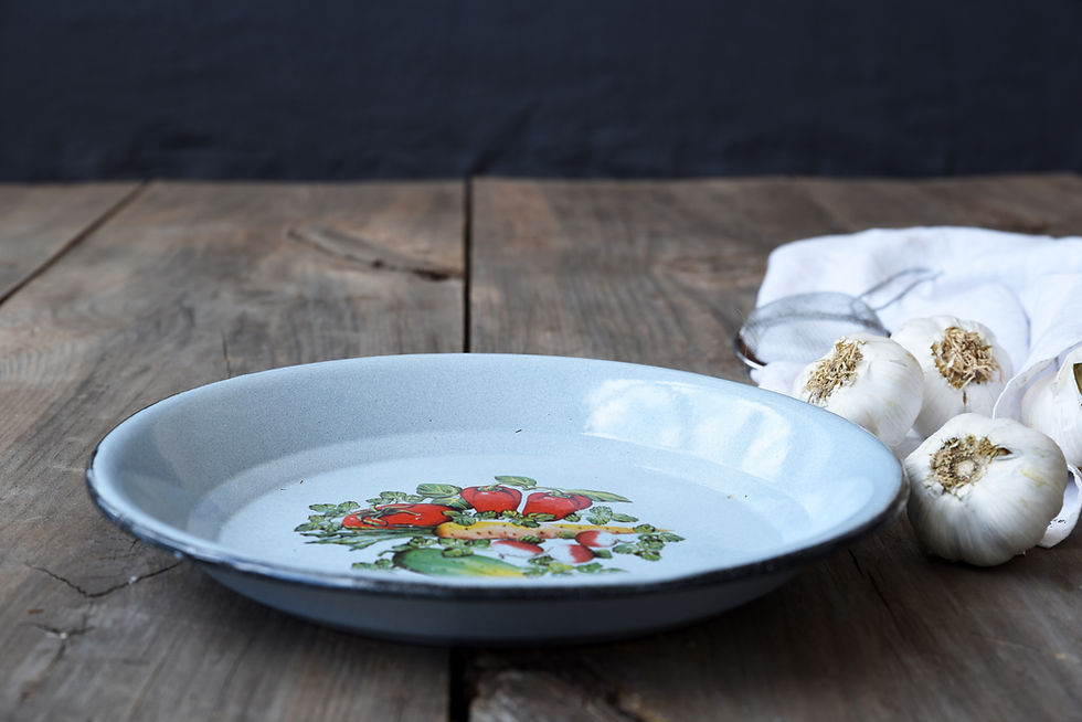 Rustic enamel platter with vegetable motif for serving and farmhouse home decor.