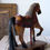 Thumbnail: Old wooden riding horse on wheels with warm rustic tones and handmade charm