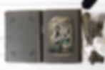 Antique postcard album with traditional photo corners for preserving family memories.
