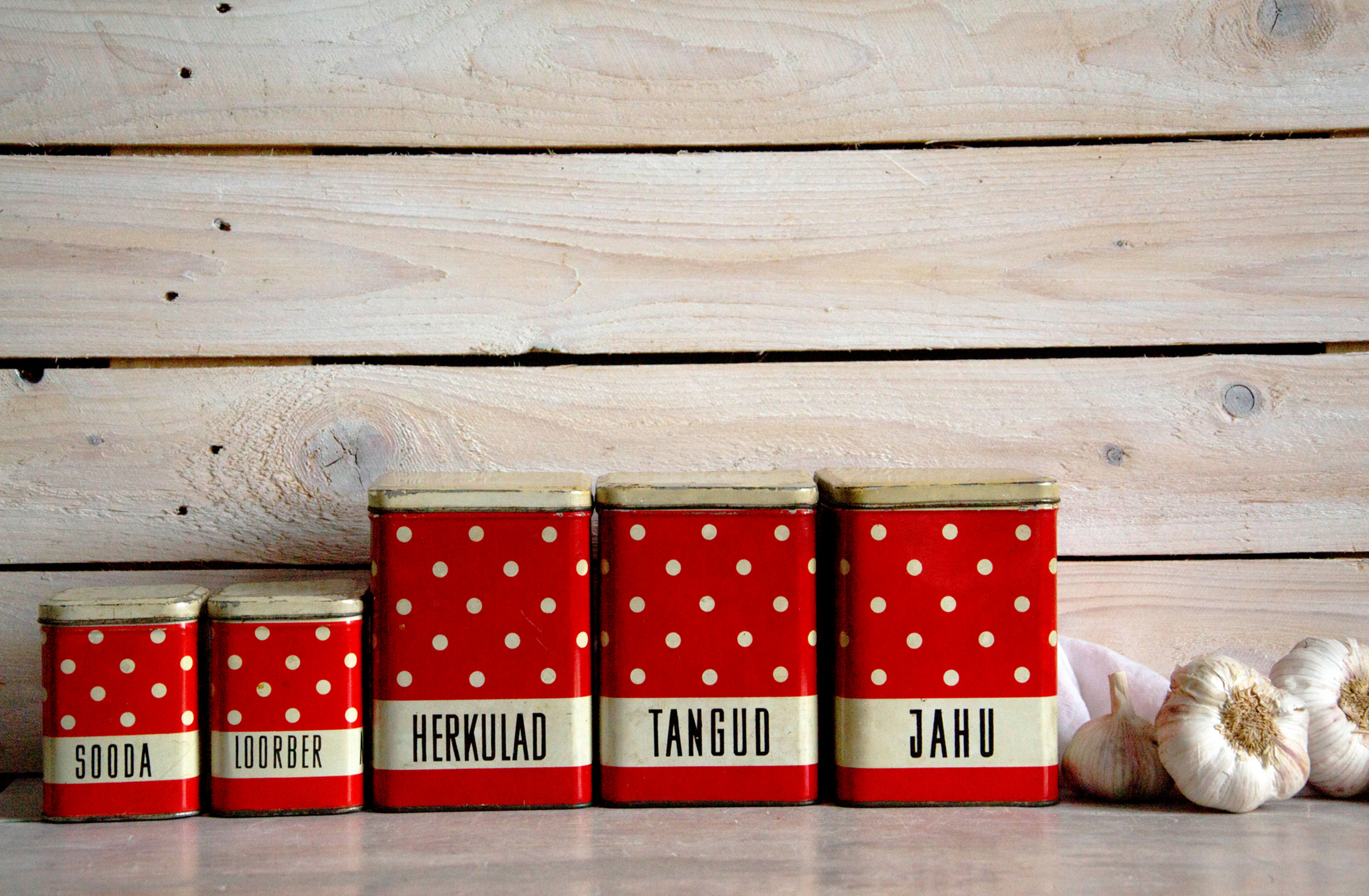 Vintage red polka dot tin canisters with Estonian labels for kitchen storage