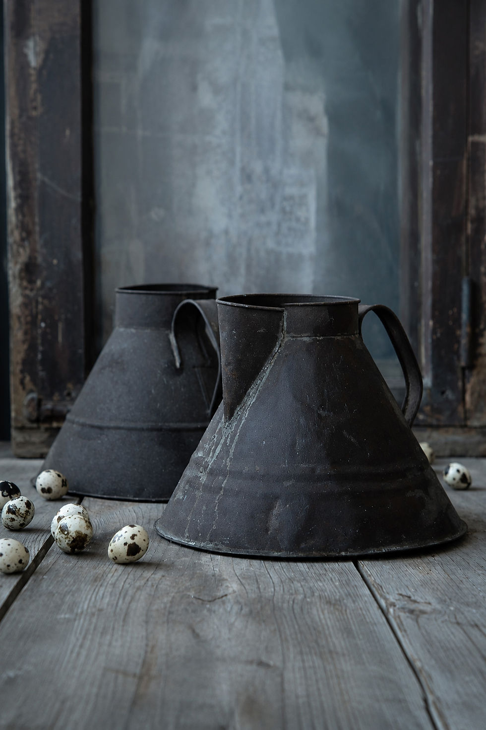 Antique metal milk can with authentic aged patina displayed on a rustic wooden table