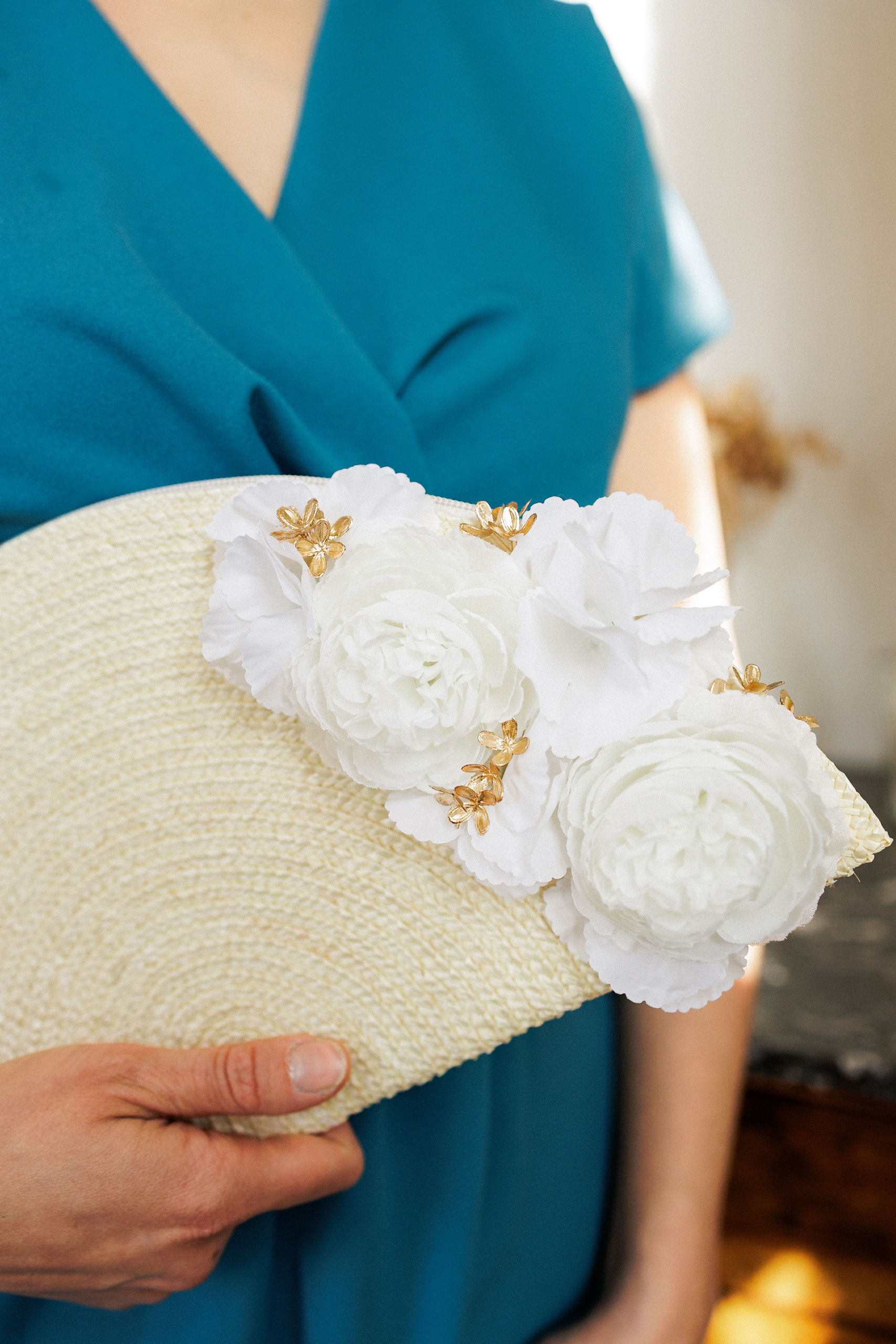 Pochette Ousté crème aux fleurs artificielles blanches et dorées