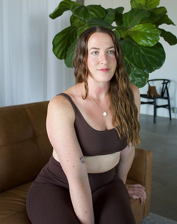portrait of a woman wearing brown yoga clothes