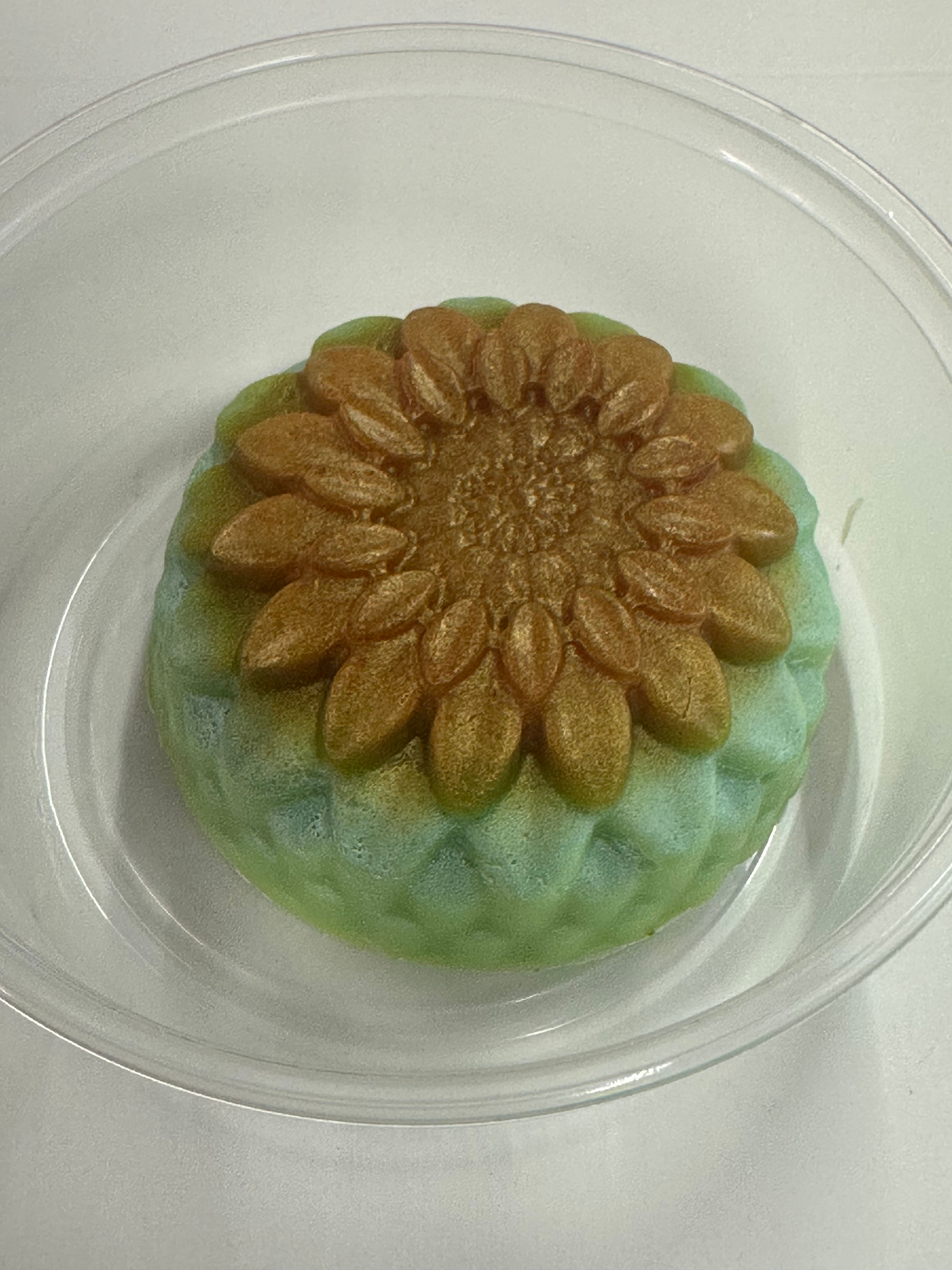 A floral green and gold treat in a clear container. Sea Moss Me Now