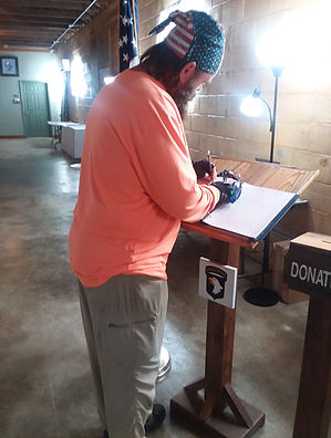 Van Booth signs guest book.jpg