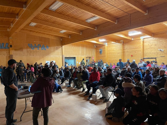 Many people are gathered in a vast community centre for an open house at Coral Harbour.