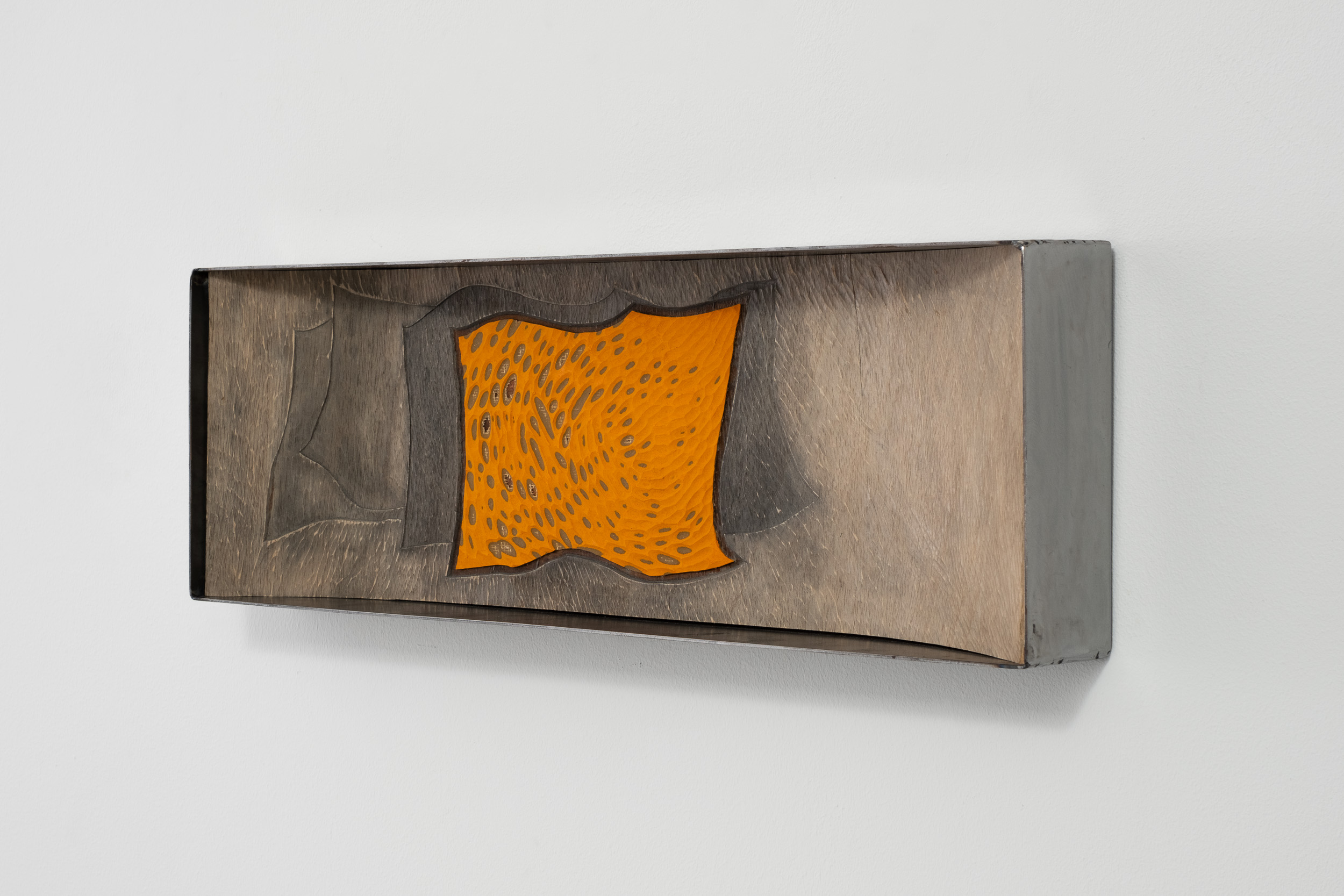 Anna van der Ploeg
The transformation of a blind electronic device into a caring voice from a hole in a shadowy remote cave wall with eyes	
2024	
Marmoleum, ink, carved plywood and steel	
77 x 26 x 10.5 cm