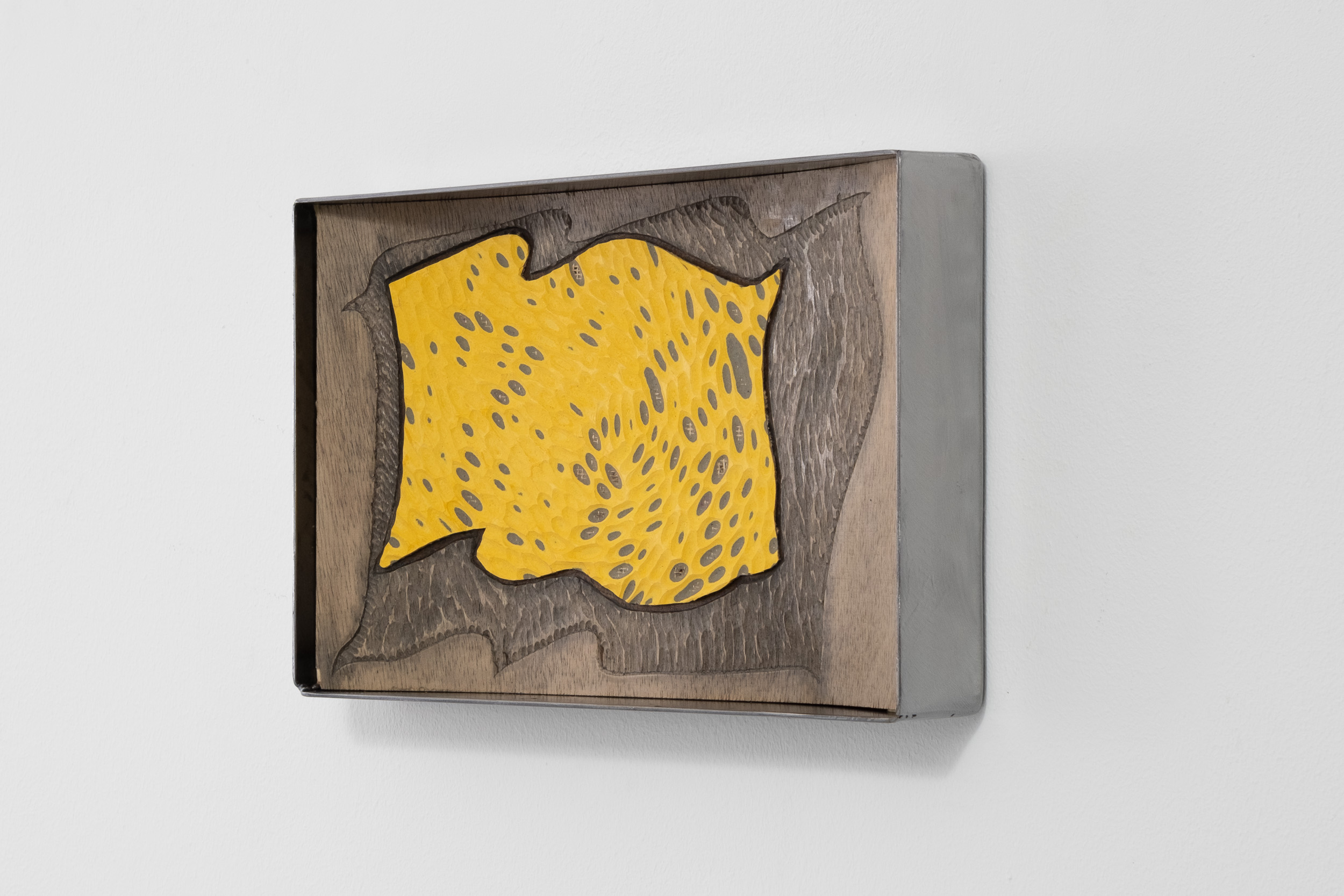 Anna van der Ploeg
Suddenly all his five teeth laugh. The laugh slams out of him and is gone.	
2024
Marmoleum, ink, carved plywood and steel
26 x 43 x 6.5 cm