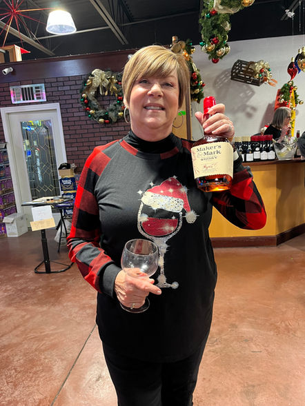 Happy customer showing off their Maker's Mark bottles with labels customized with calligraphy by Emily Rose Cooper