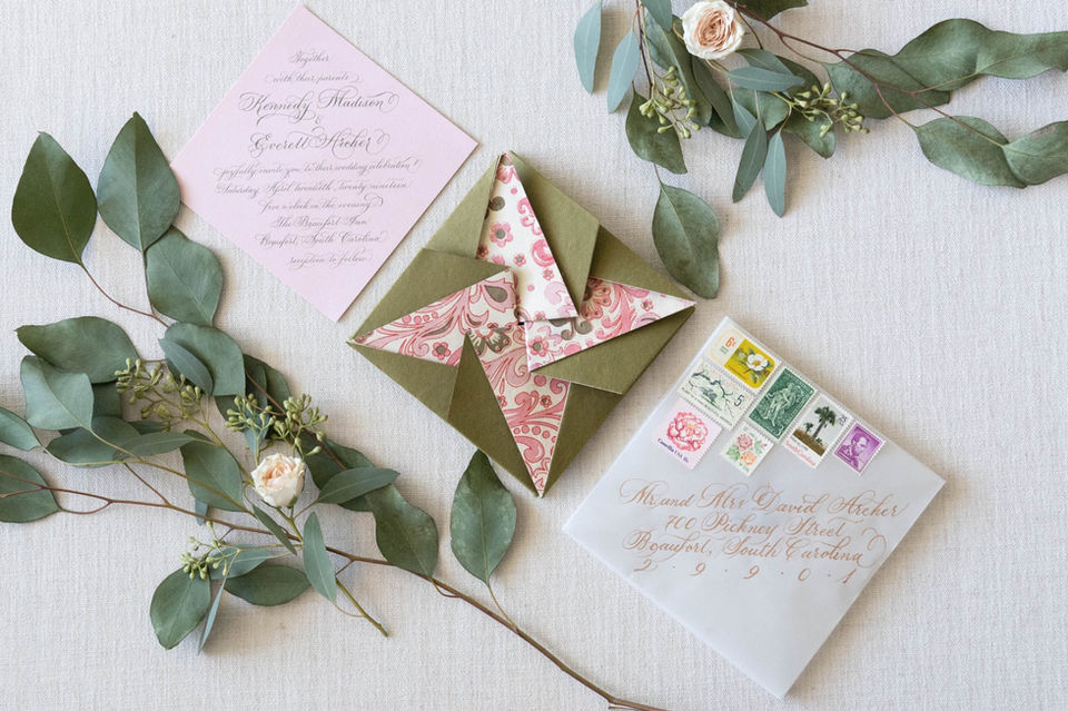 Custom wedding invitation suite in classic flourished copperplate calligraphy with origami handmade paper inner envelope, vellum outer envelope, gold calligraphy envelope addressing and custom vintage postage stamp set.