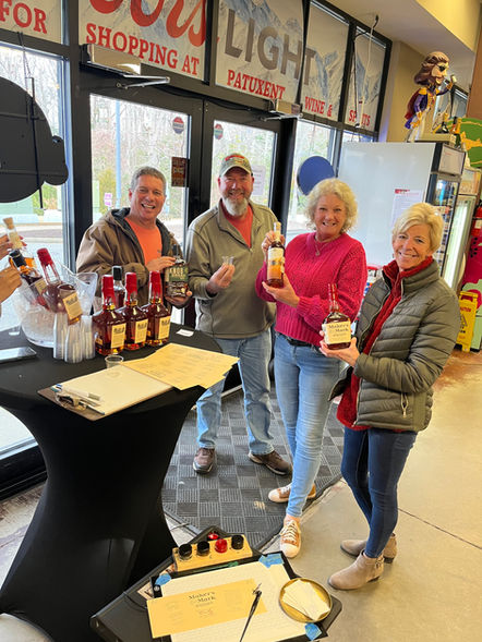 Happy customers showing off their Maker's Mark bottles with labels customized with calligraphy by Emily Rose Cooper