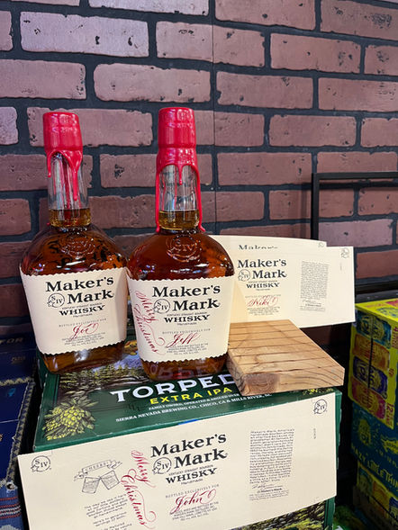 Calligraphy on two  Maker's Mark bottles done on-site by Emily Rose Cooper for a holiday brand activation event
