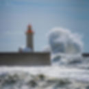 Lighthouse standing resilient against powerful ocean waves, symbolizing resilience in AI and digital transformation strategies for long-term business growth.