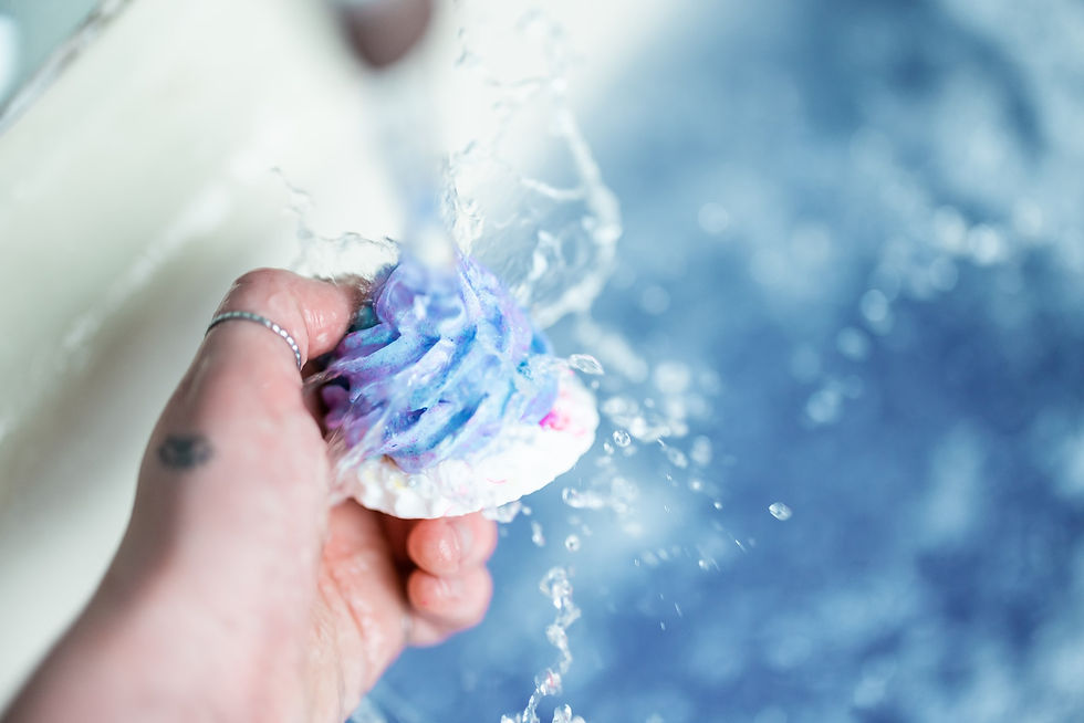 Frosting of a cupcake bath bomb being held under running water