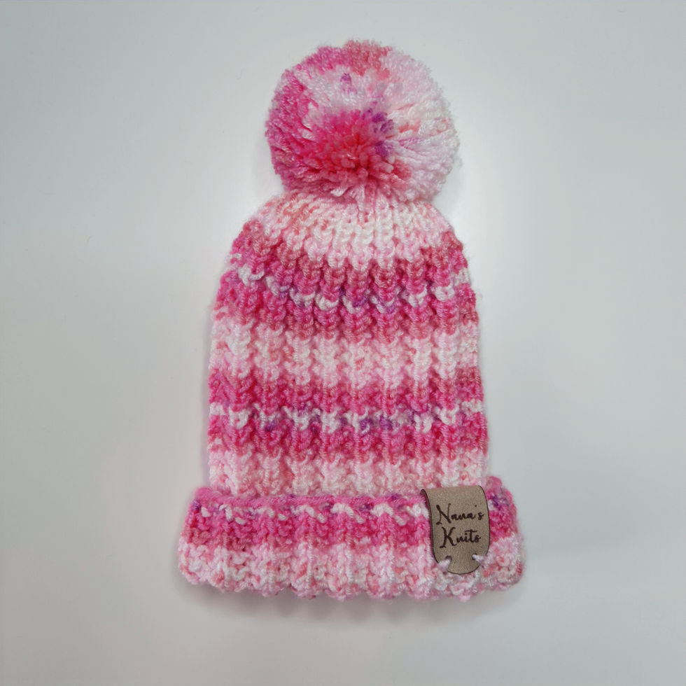 Vibrant pink and white striped knitted beanie hat with pom-pom.