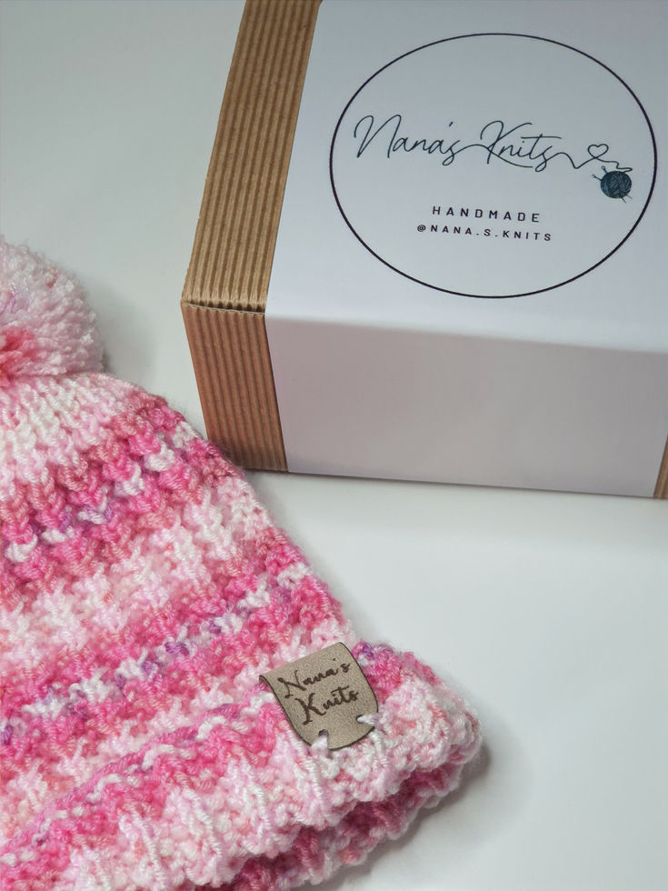 Pink and white knitted beanie, "Penny Katelyn's Handmade with Love" box.