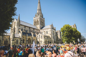 A large crowd at Chichester Pride Parade outside Chichester Cathedral.