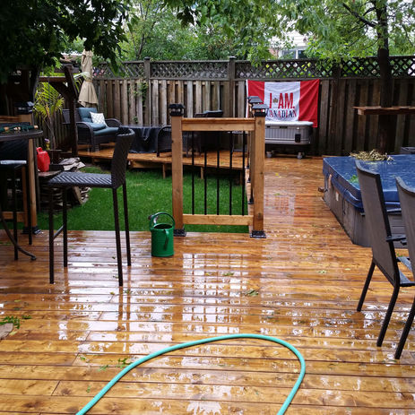 Outdoor entertainment backyard space in Burlington with fire pit, seating, and modern deck