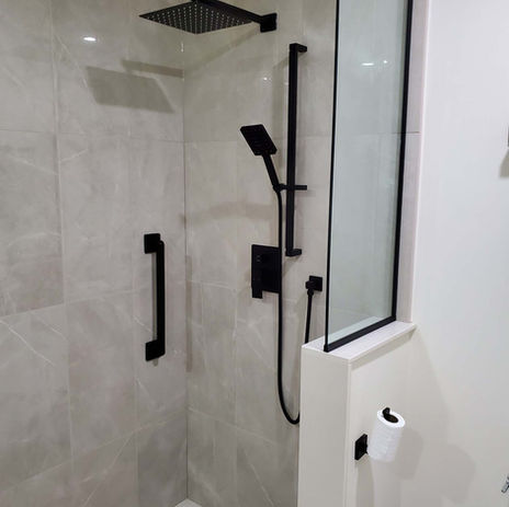 Modern bathroom remodel in Oakville featuring floating vanity and walk-in shower