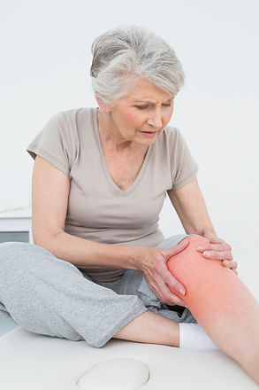 Senior woman with her hands on a painful