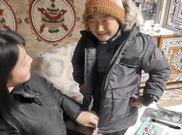 Mongolian boy receiving a winter kit