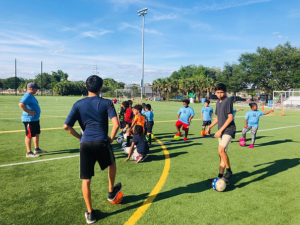 soccer-coaches-teaching-kids