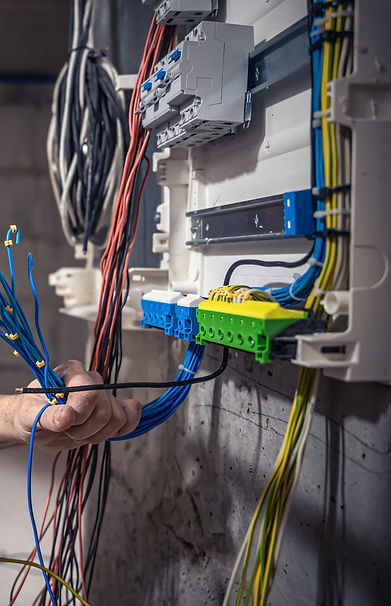 male-electrician-works-in-switchboard-with-an-electrical-connecting-cable_edited.jpg