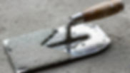 a-trowel-laying-on-a-cement-surface-photo.jpg