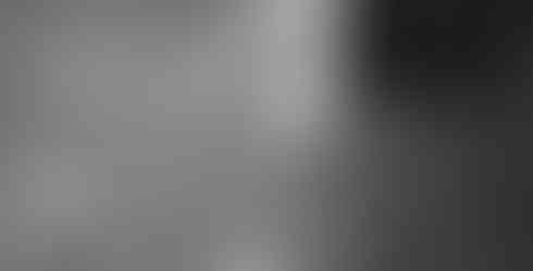 Water on the tiled floor, showing reflections of the ceiling light.