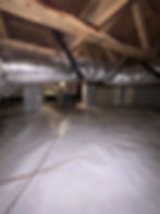 High angle view of a clean, dry crawl space with vapor barrier and insulation