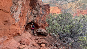 Hiker approaching hidden Caves off the trail in Long Canyon
