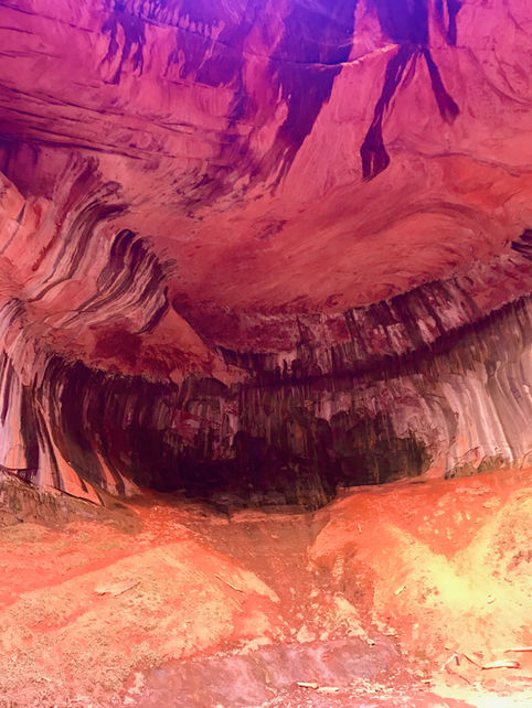 Curving sandstone walls with swirling textures inside an alcove