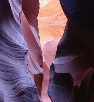 Undulating sandstone formations with deep shadows and reflected light