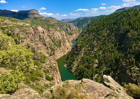 Curecanti Creek canyon overlook with green river below and steep rocky walls