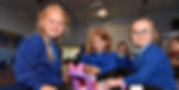 Children sat on the floor playing with dolls