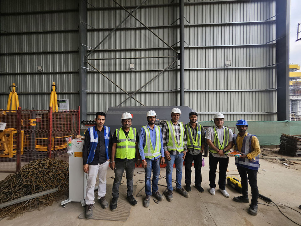Seven men in safety gear at a construction site