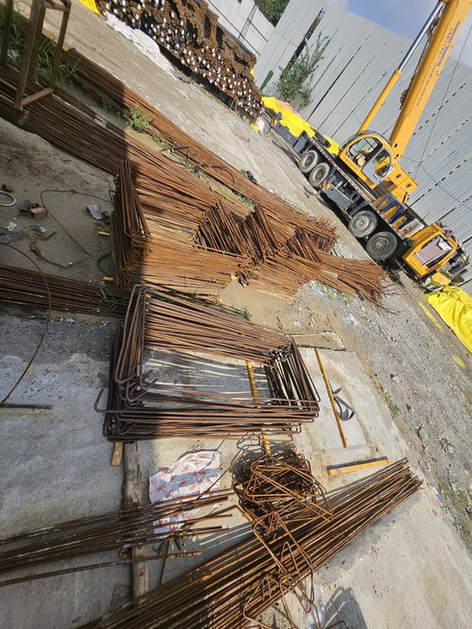 Rebar and yellow crane at construction site