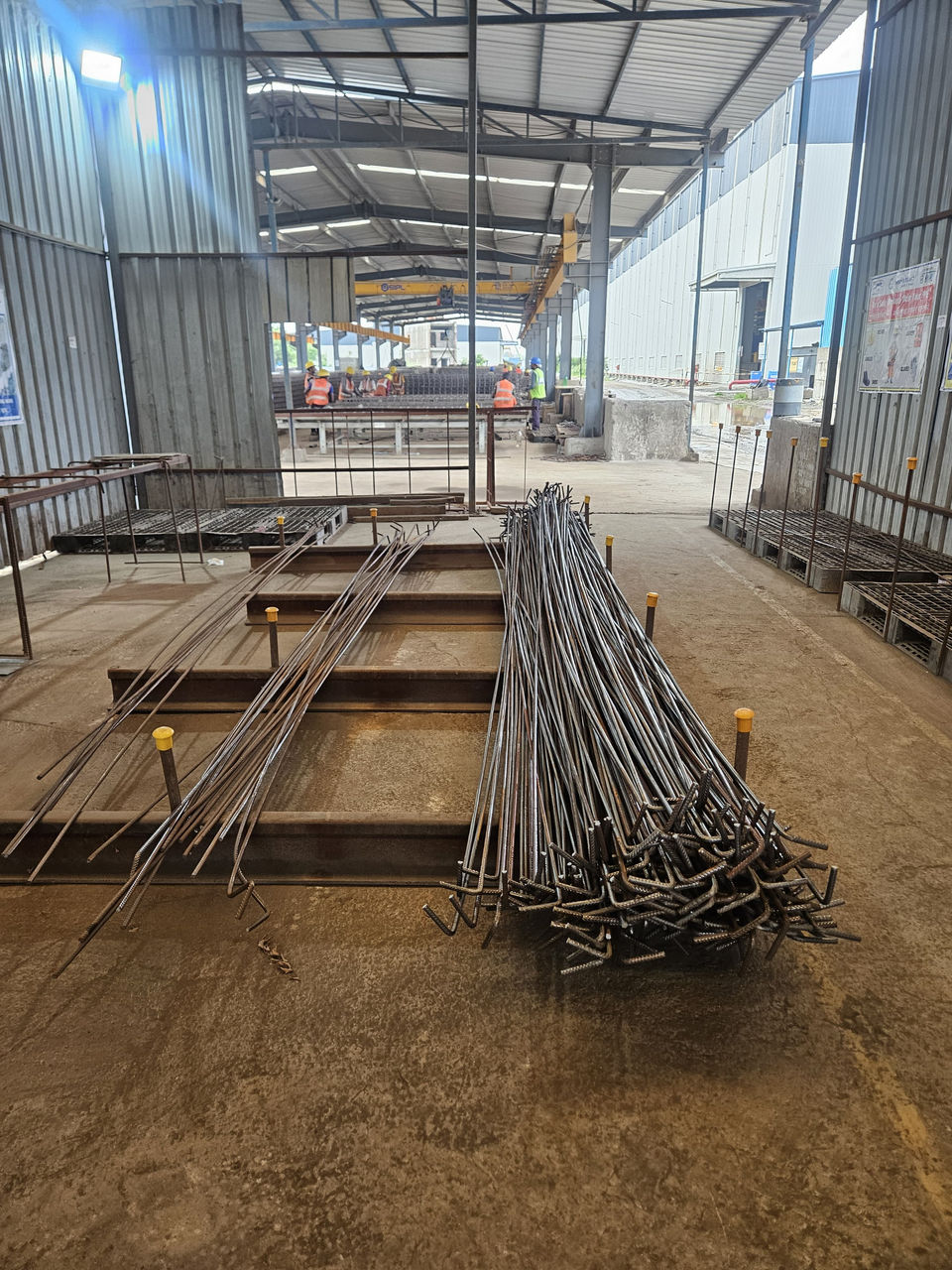 Steel rebar stacked in a fabrication workshop