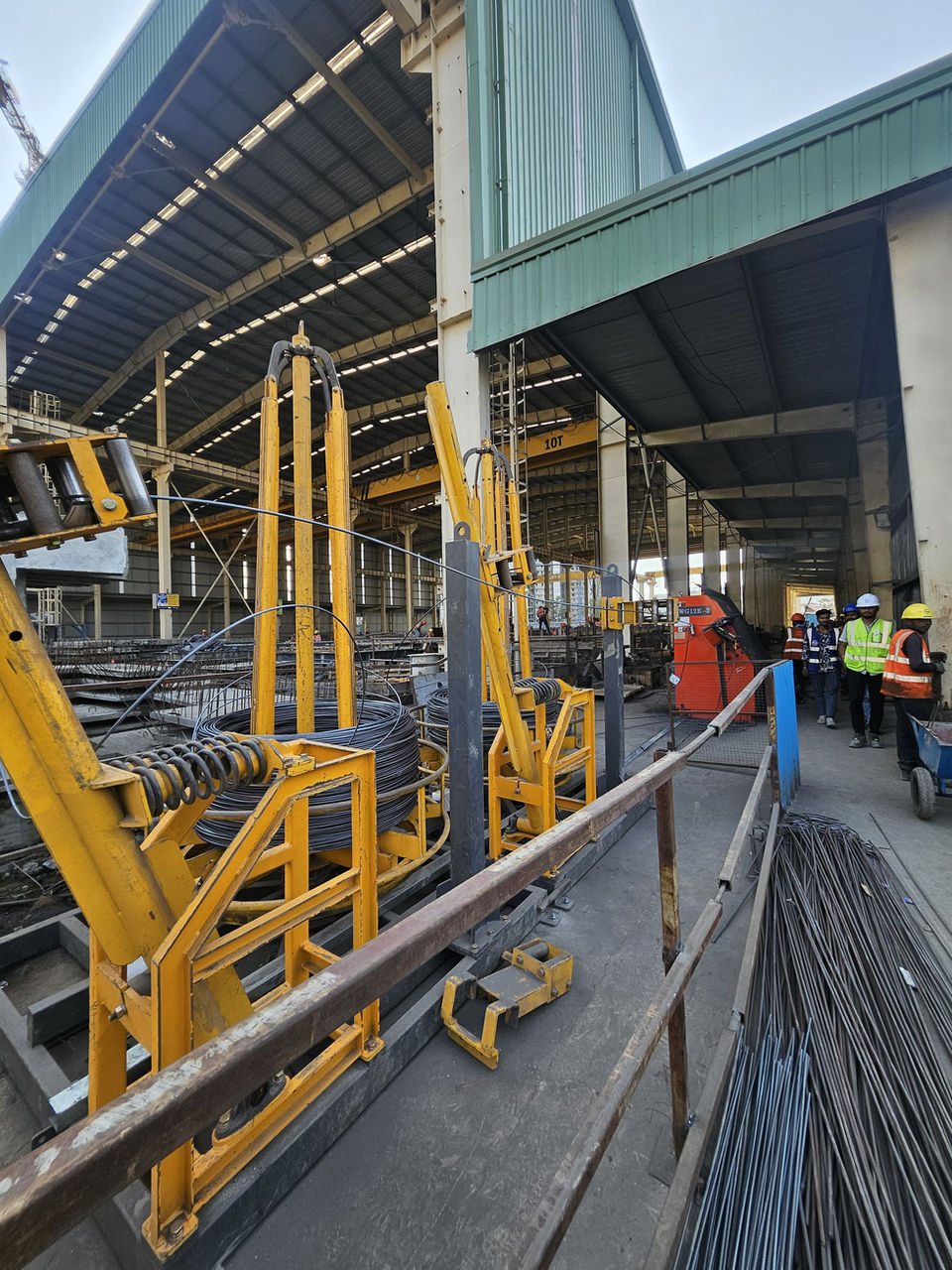 Yellow rebar processing machinery in an industrial plant