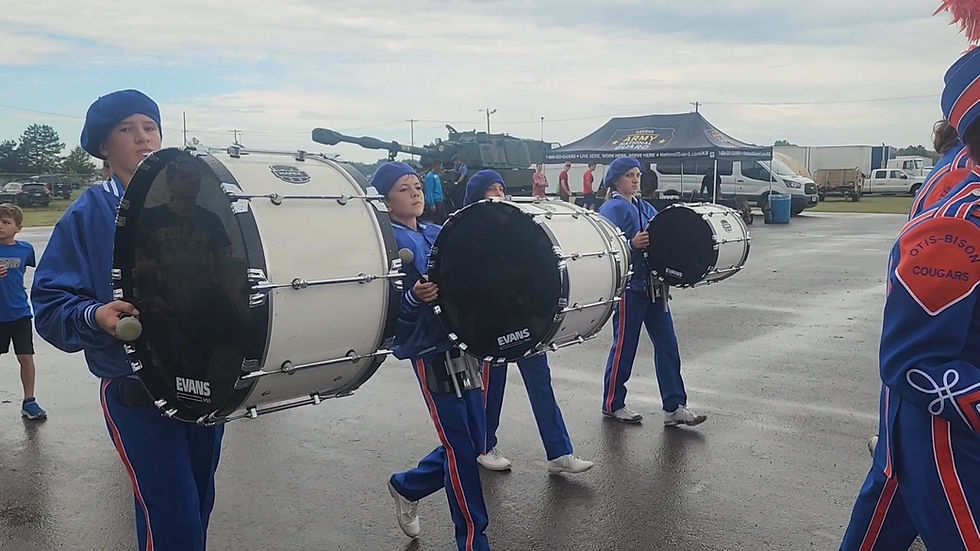 Bass drum players marching