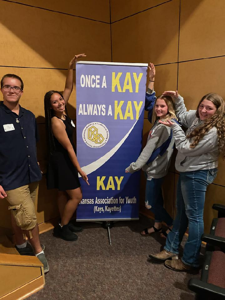 Nevaeh and classmates posing with KAY Banner