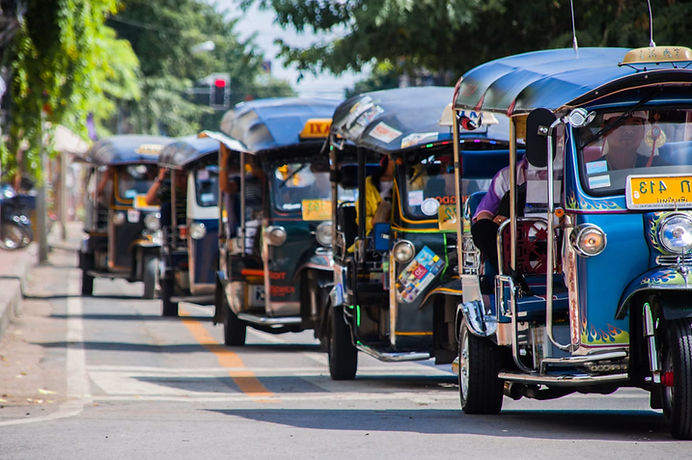 Tuk-tuks traversing the streets of Bangkok, Thailand.
