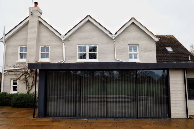 a house with a lot of windows and curtains