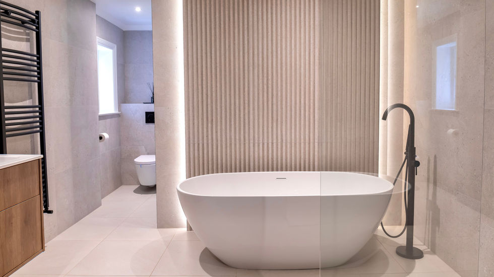 a luxury bathtub in a bathroom next to a toilet
