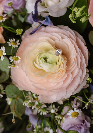 Lauren and Joel's wedding bands on her bouquet