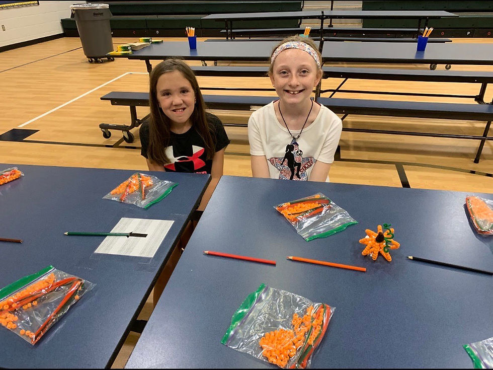 Alyssa volunteering with a friend at our Meals on Wheels service project where we made fall themed crafts for the home delivery meal recipients.