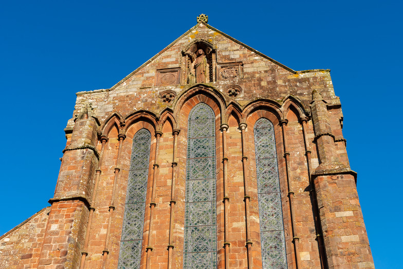 Exterior of old English priory in the afternoon light.