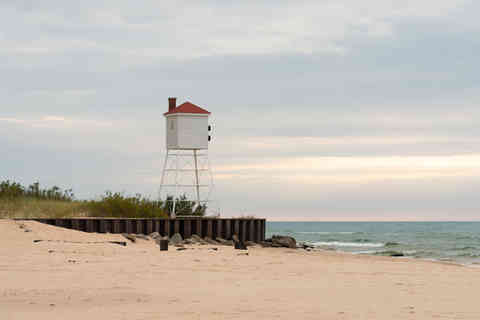 Fog horn tower on Lake Michigan with late afternoon lighting at Big Sable Point in Ludington, Michigan, USA.