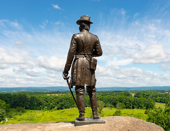 The Gouverneur Kemble Warren Monument on Little Round Top overlooking the battlefield at Gettysburg National Military Park in Gettysburg, Pennsylvania, USA.